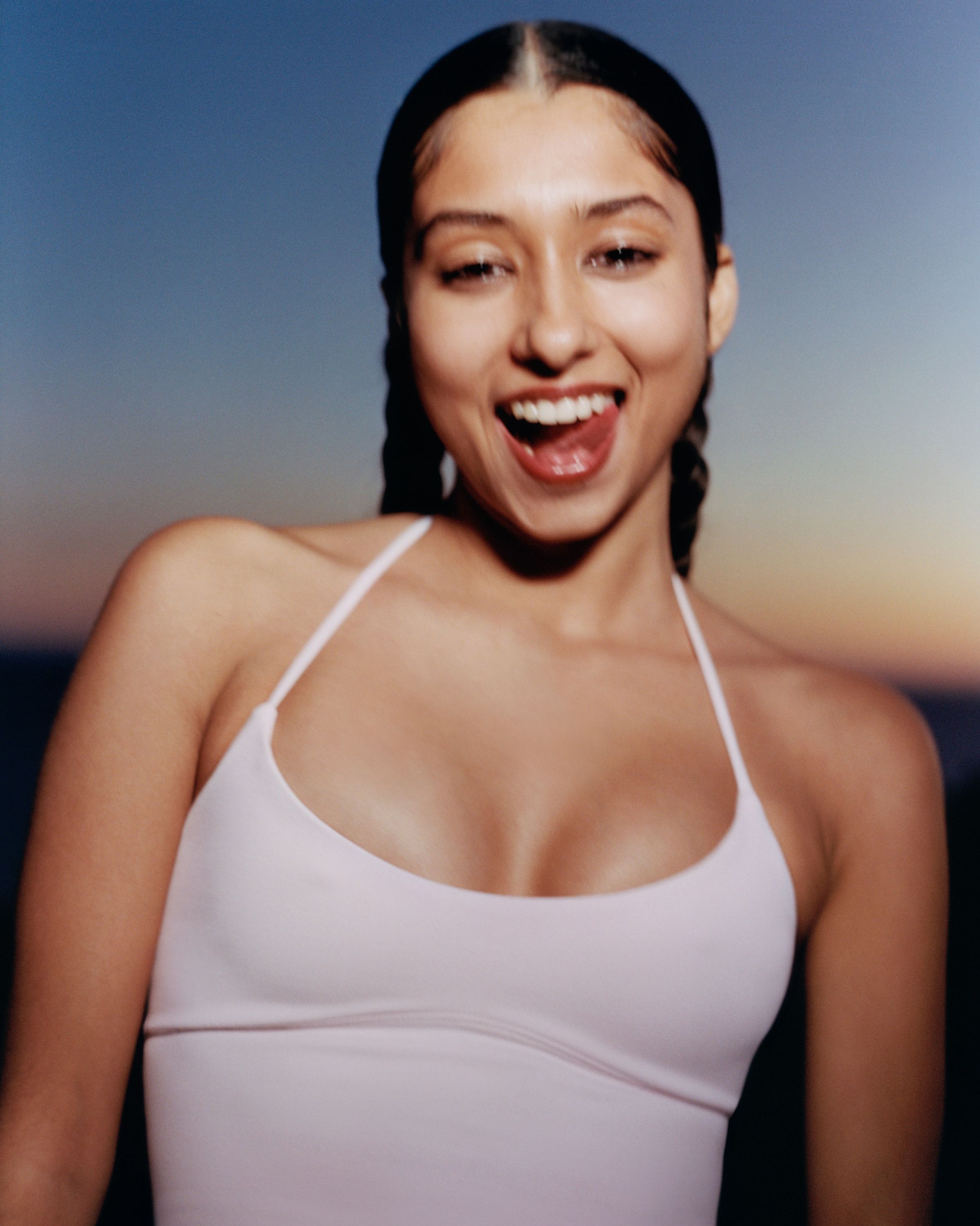 Tank Air SS24 Essentials shot in Los Angeles by Alex Leese. Model wearing the Spill Halter in Baby Pink with a gradient sunset in the background.
