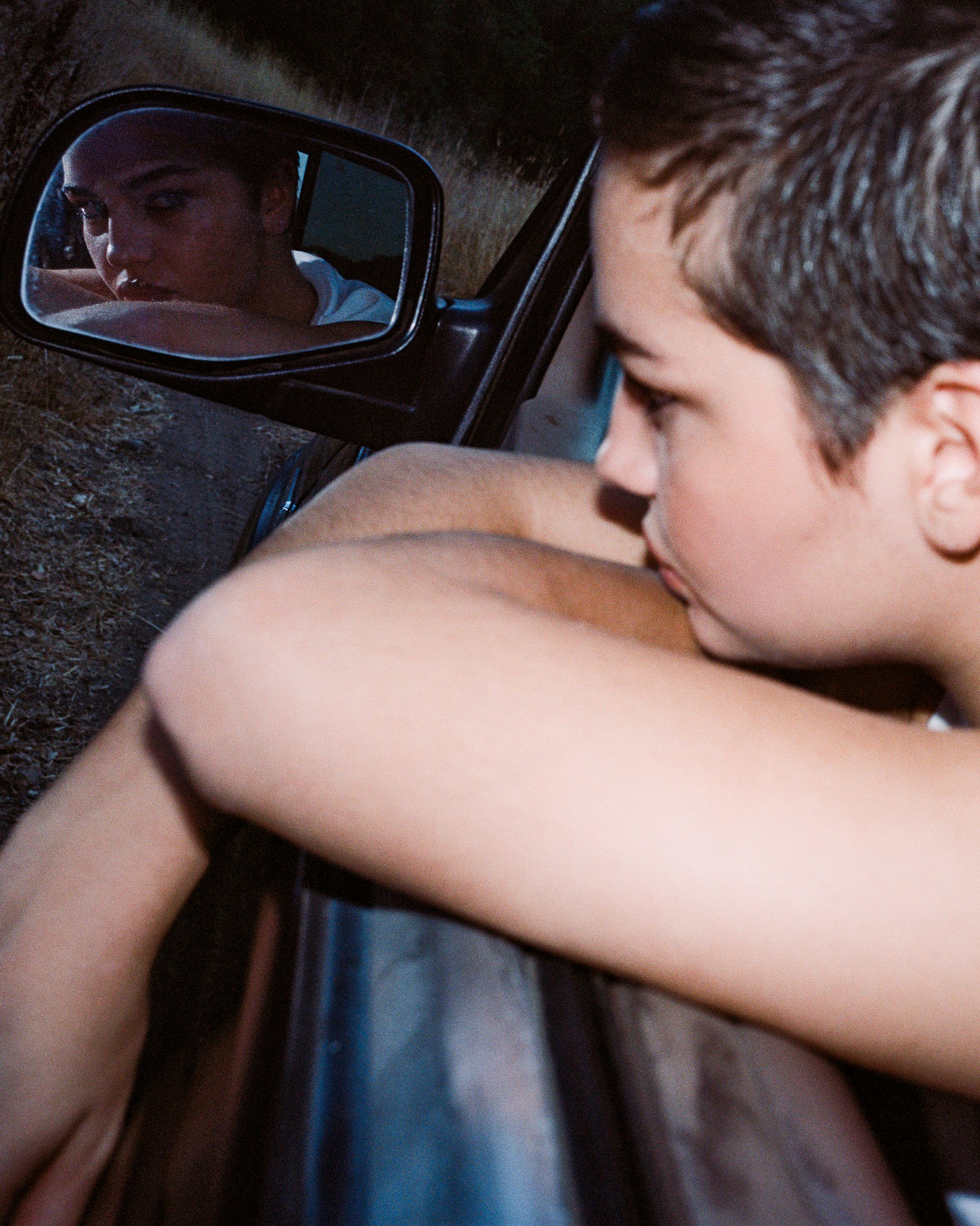 Tank Air FW25 Essentials shot in Los Angeles by Tank Air. Model looking into camera from car mirror.