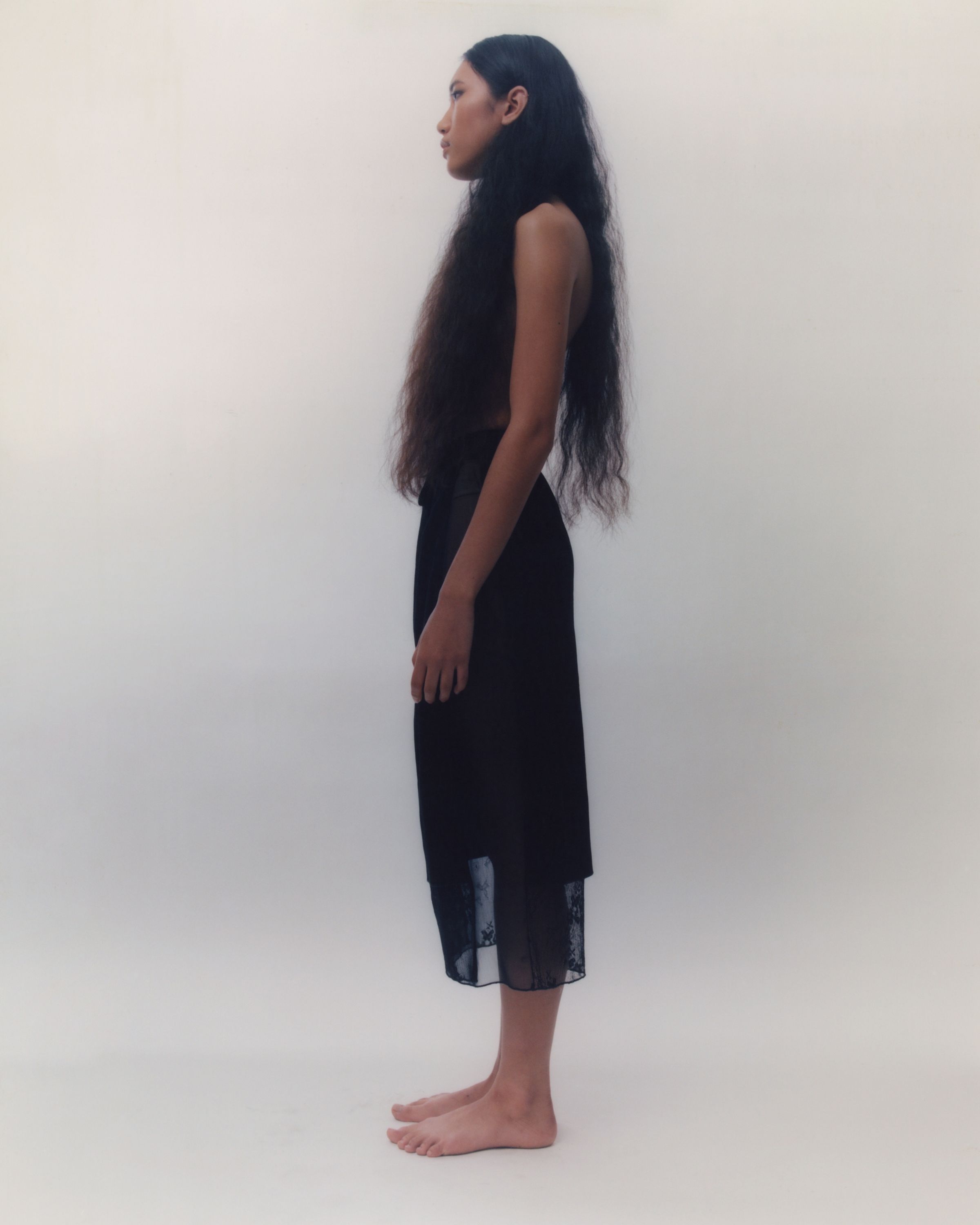 Tank Air SS20 Ready-to-Wear shot in Los Angeles by Erika Kamano. Model in the Mai Thai top and the Sheer Sarong in studio from a side view.