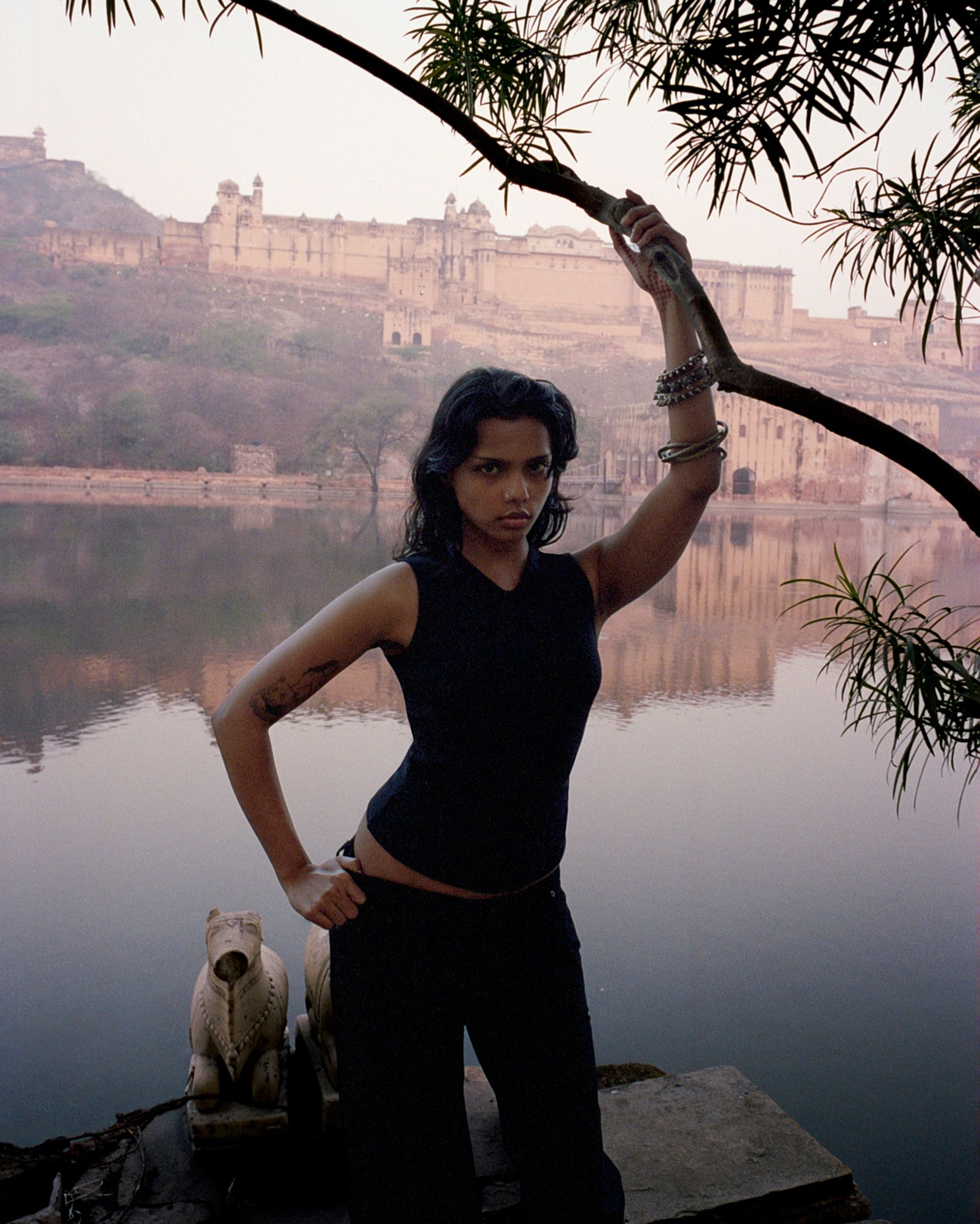 Tank Air SS26 Essentials shot in Jaipur by Erika Kamano. Model wearing the Volar Tank in Black while standing in front of lake.