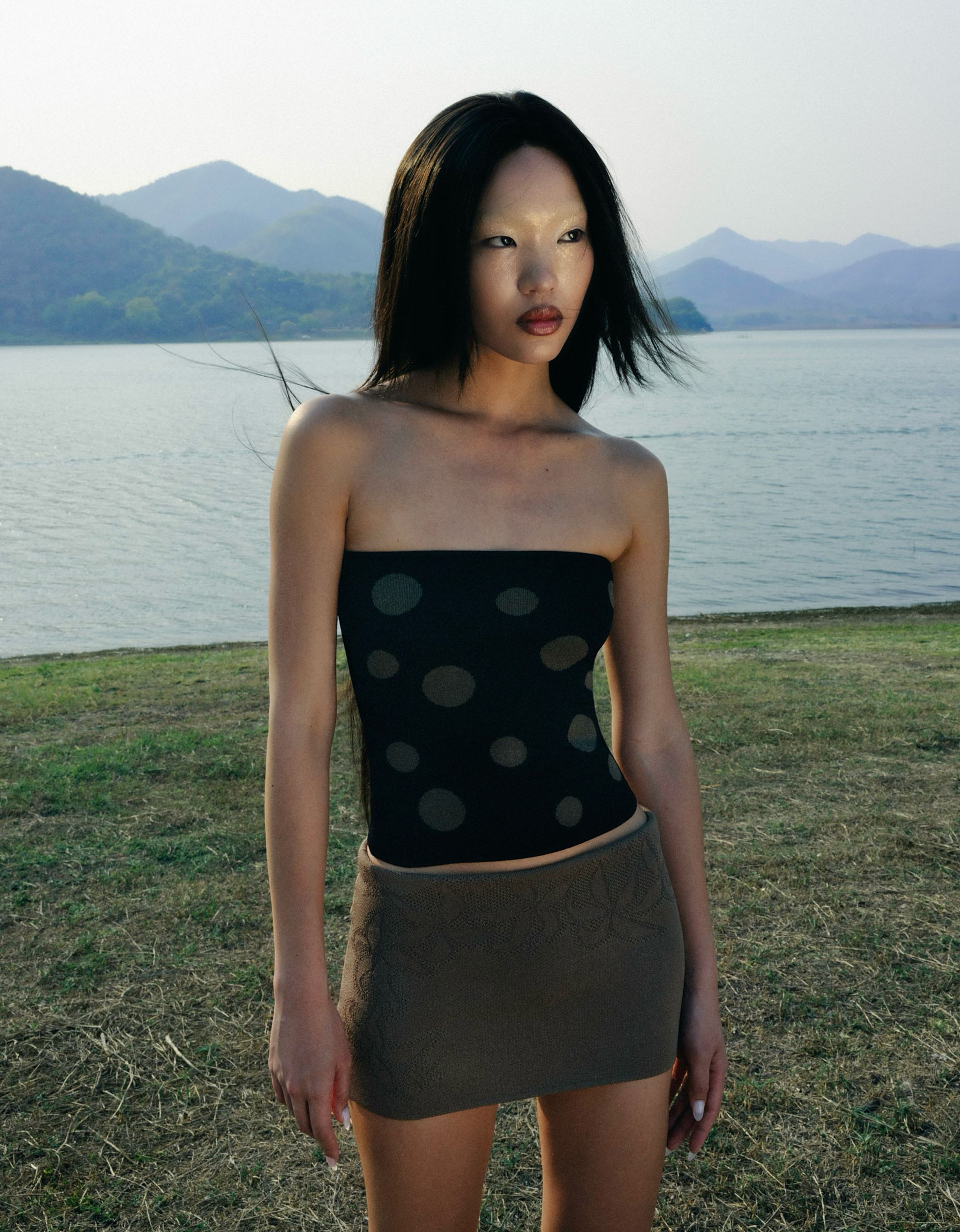 Tank Air SS23 Ready-to-Wear shot in Bangkok by Erika Kamano. Model wearing the Bubbles Tube Top in Black and the Plumeria Girl Mini Skirt in Olive in nature.