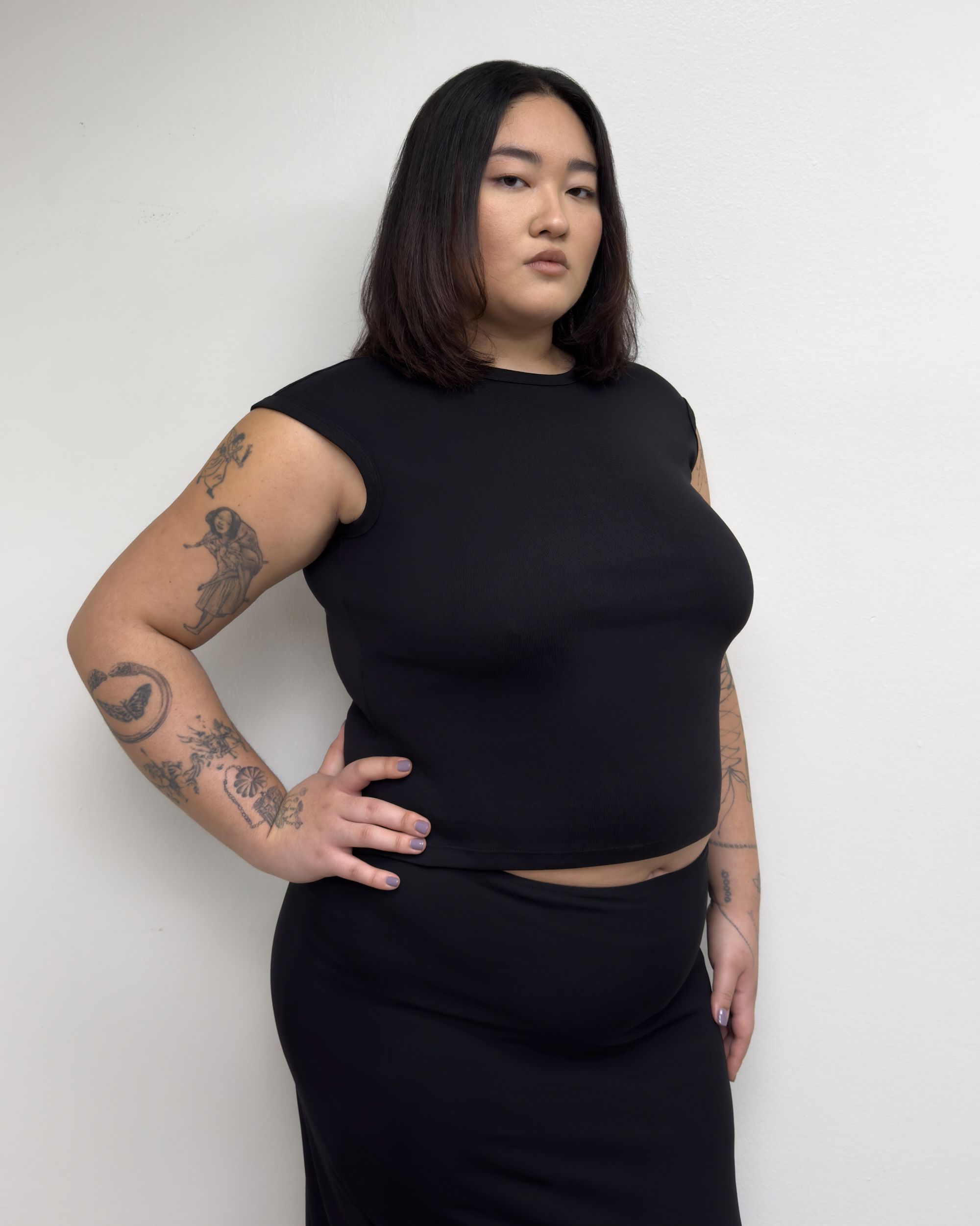 Tank Air SS25 Essentials shot in Los Angeles by Tank Air. Model wearing Corner Tee in Black against white wall.