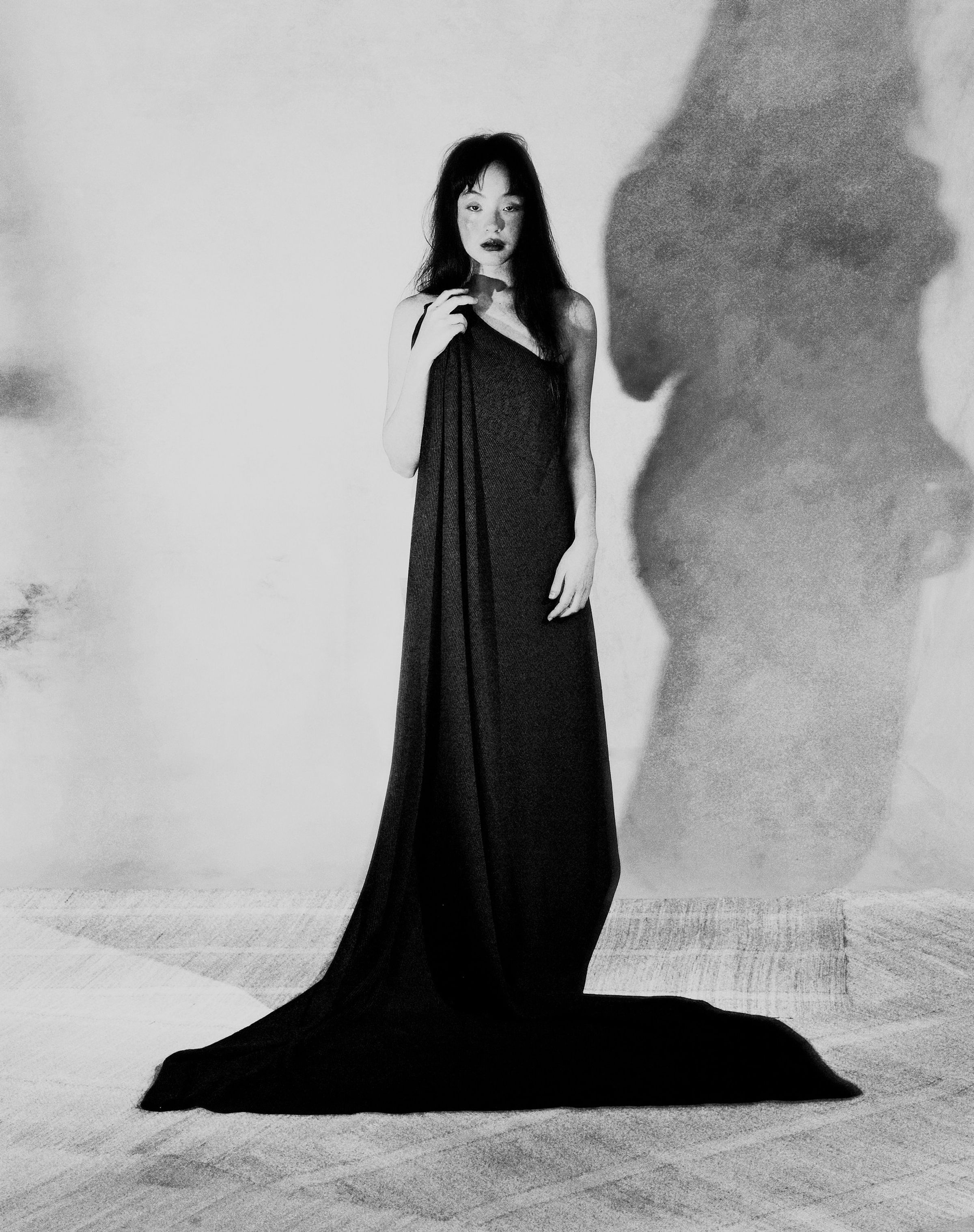 Tank Air FW25 ready-to-wear shot in Paris by Joe Lai. Model wearing the Tank Air Throw around her body in a full body portrait.