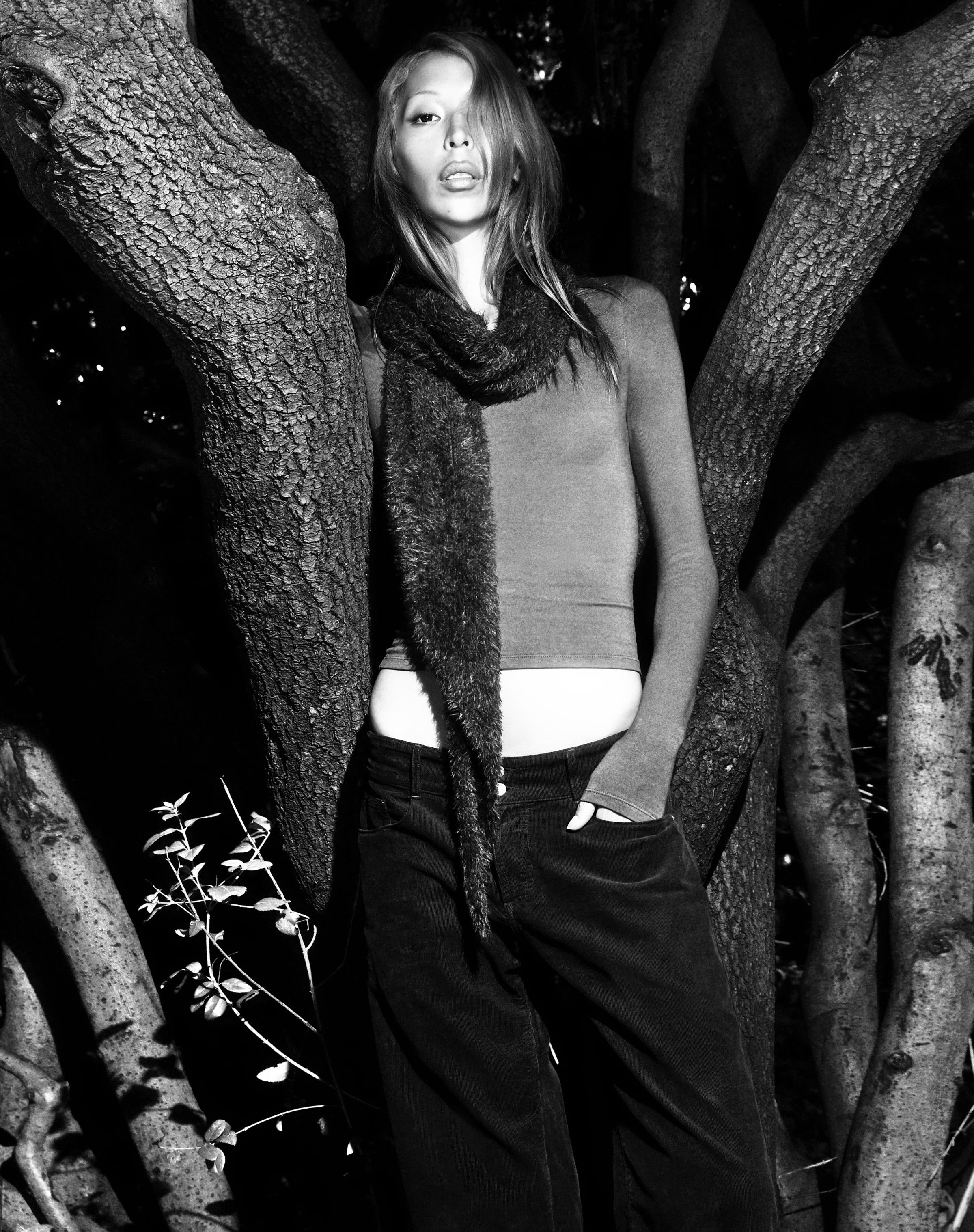 Tank Air FW25 ready-to-wear shot in Paris by Joe Lai. Model wearing the a long sleeve top with the Meditation Pants and Fluffies Scarf in Black standing near a tree.