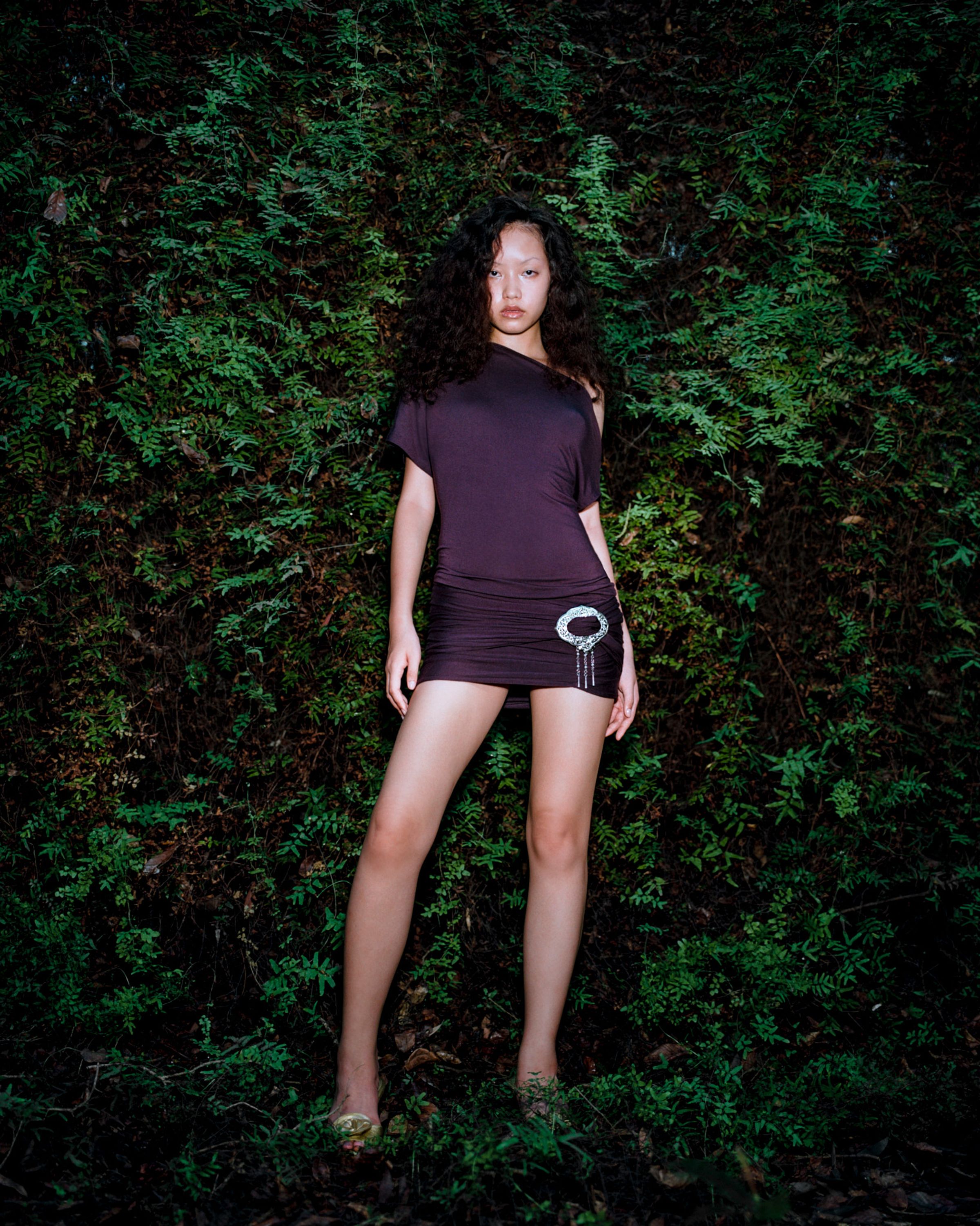 Tank Air SS24 ready-to-wear shot in Bangkok by Erika Kamano. Model wearing the Northern Silver Mini Dress in Eggplant in tropical forest.