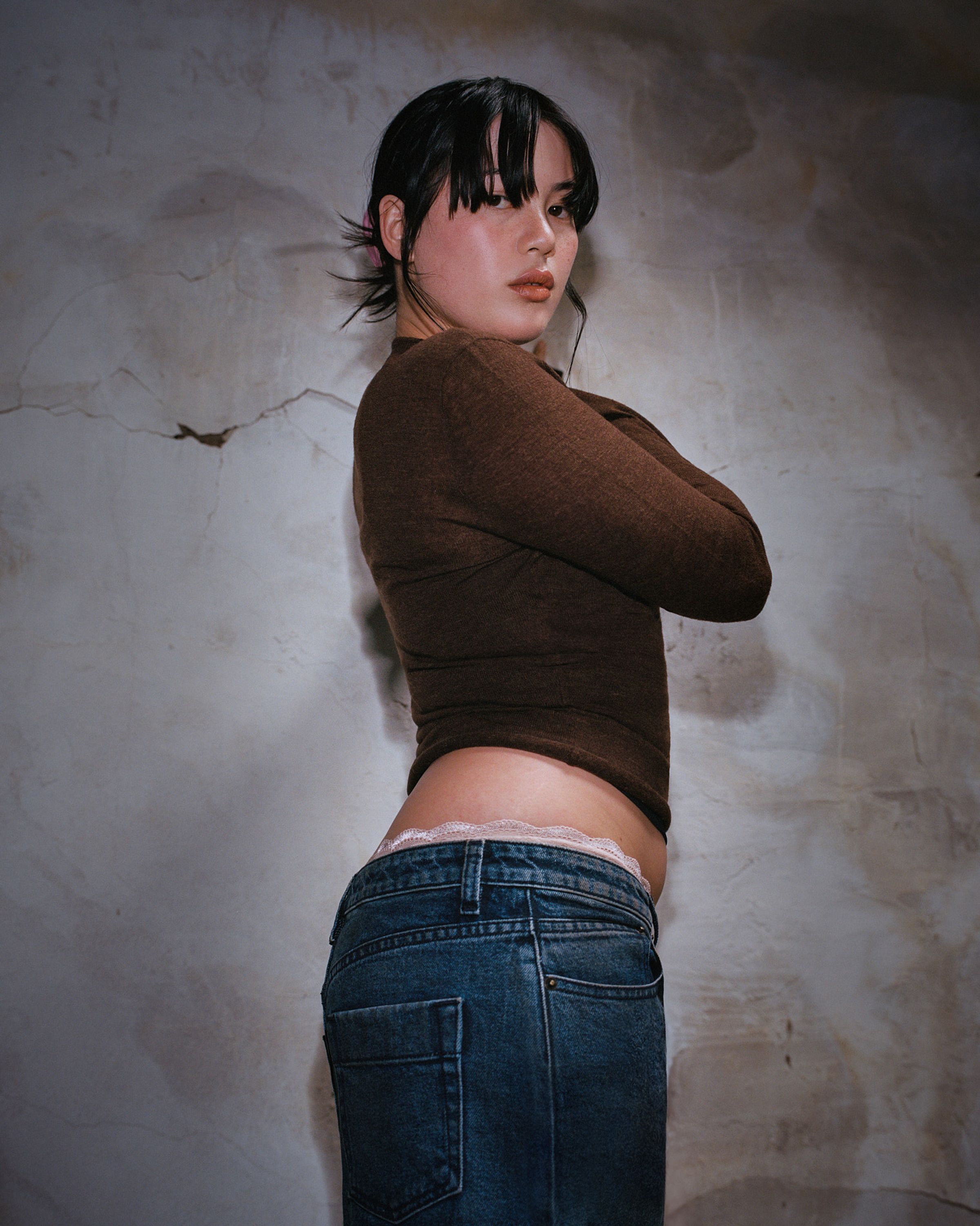Tank Air SS24 Denim shot in Los Angeles by Tank Air. Model wearing the Cocoon Denim Maxi Skirt while standing against a wall.