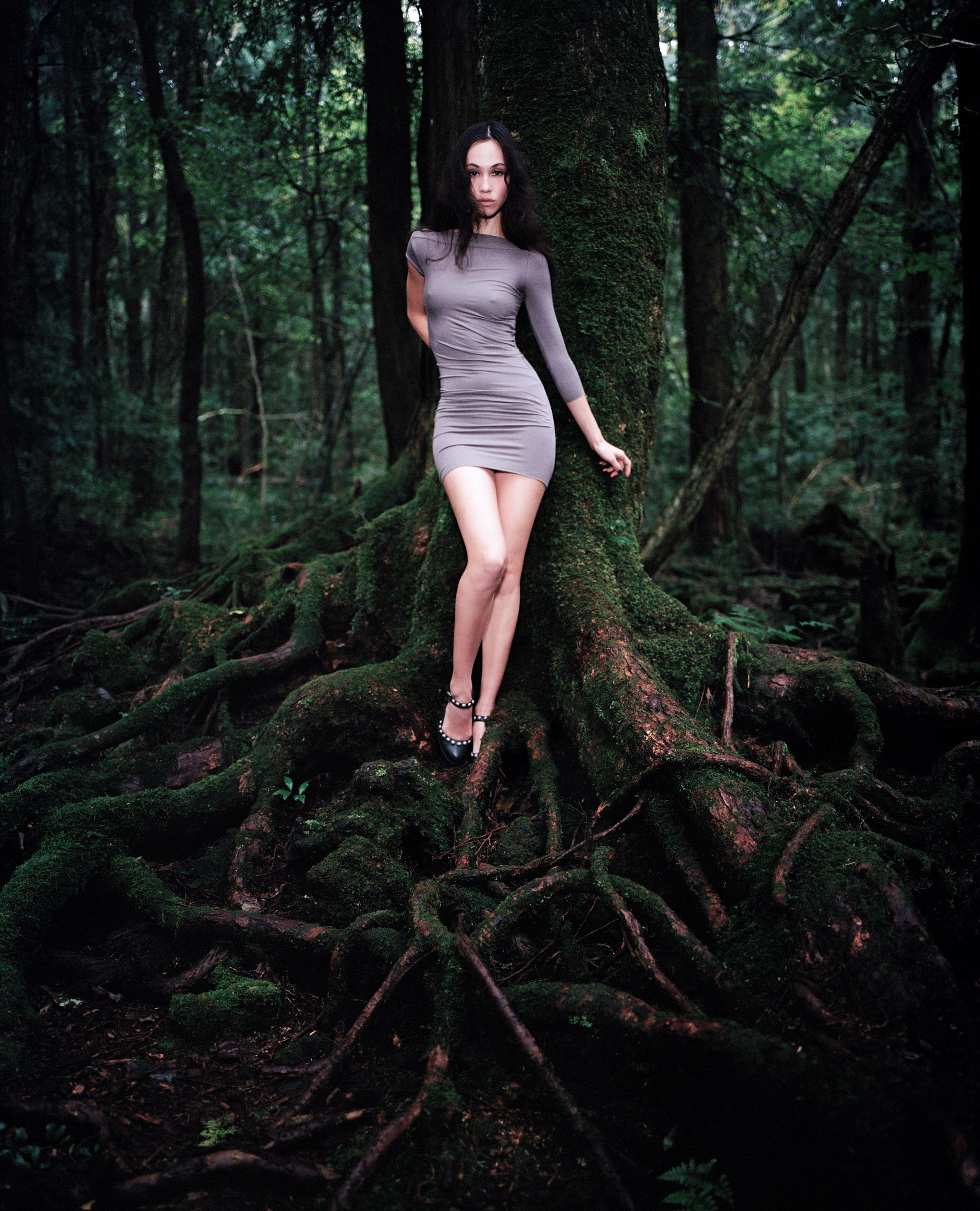 Tank Air FW24 ready-to-wear shot in Tokyo by Erika Kamano. Model wearing the Asymmetrical Pleated Mini Dress in Clay in a mossy forest.