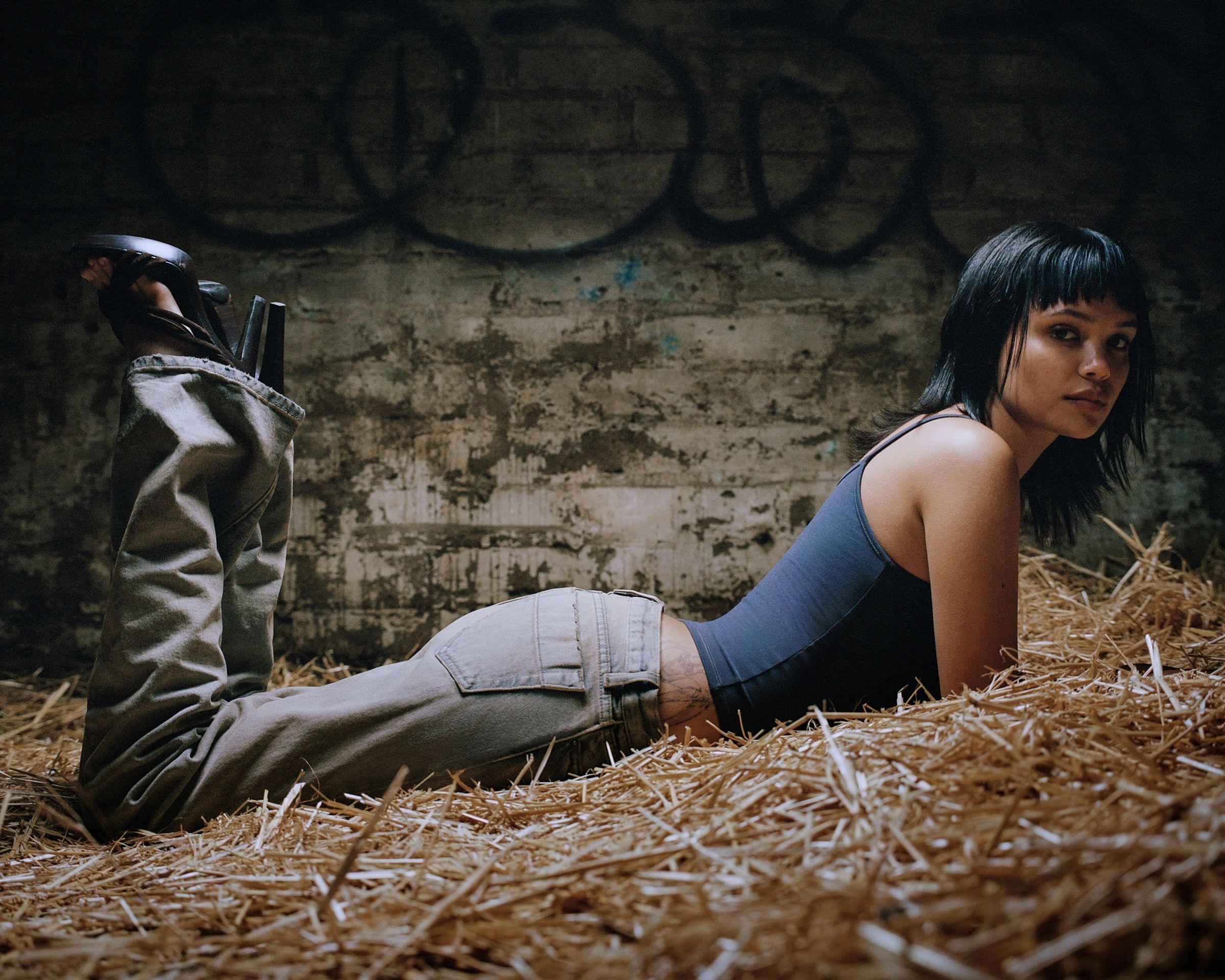 Tank Air SS24 Denim shot in Los Angeles by Tank Air. Model wearing the Low Slung Jeans while lying in hay.