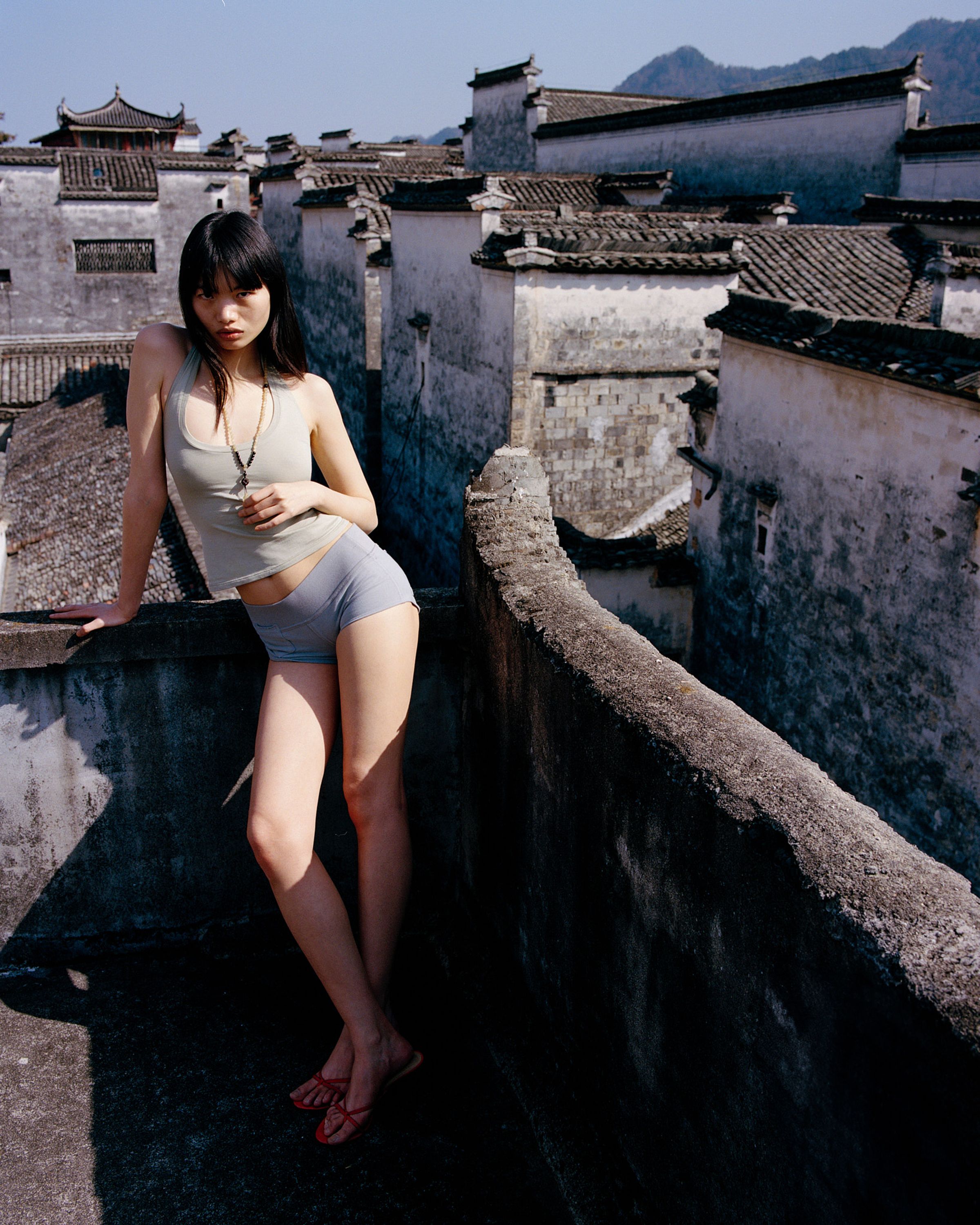 Tank Air SS26 Essentials shot in Nanping Village in Erika Kamano. Model wearing the Teardrop Halter in Celadon and Bliss Hot Pants in Grey while standing on rooftop.