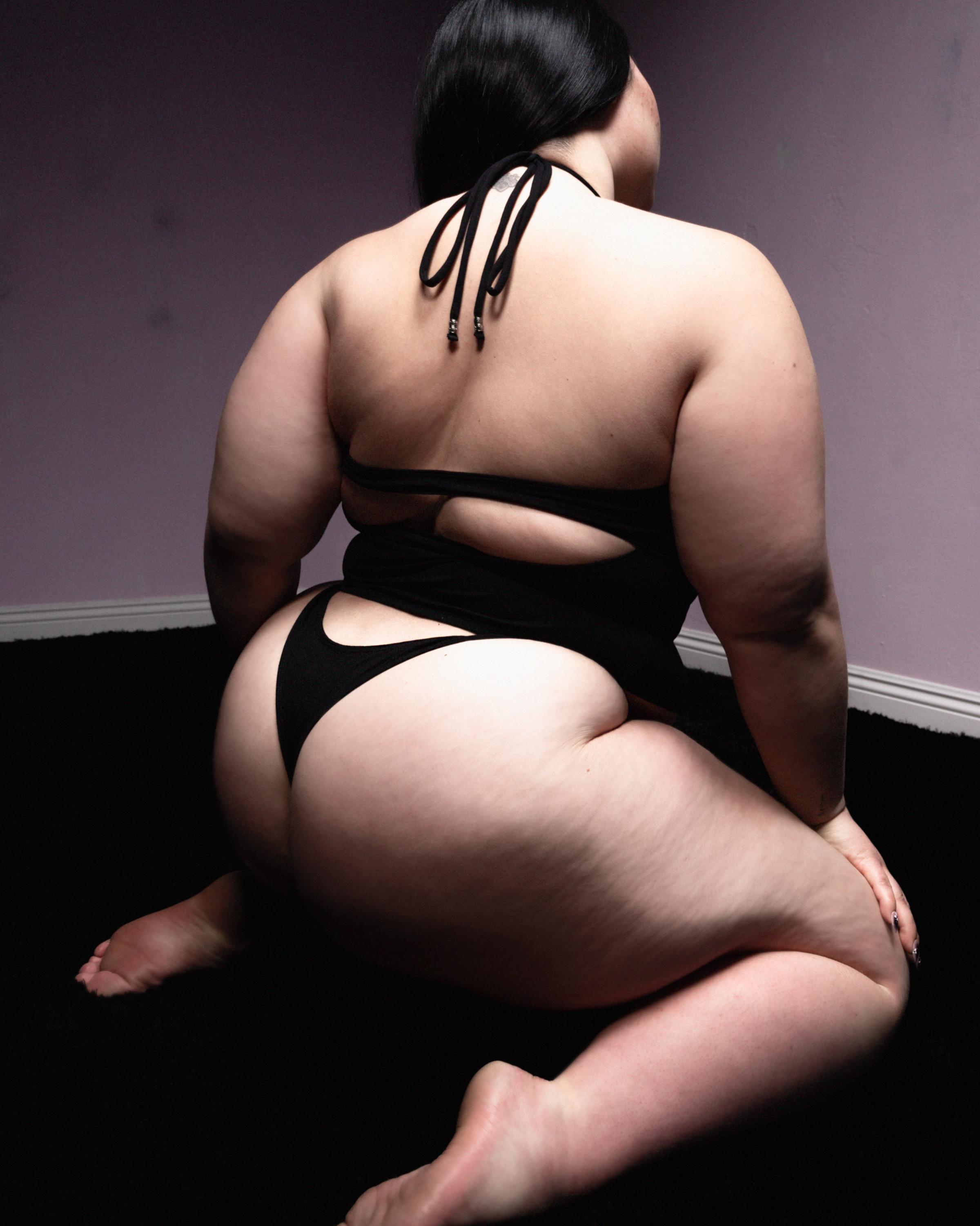 Tank Air SS23 Essentials shot in Los Angeles by Erika Kamano. Model wearing the Spill Halter in Black while kneeling on the floor in a from the back.