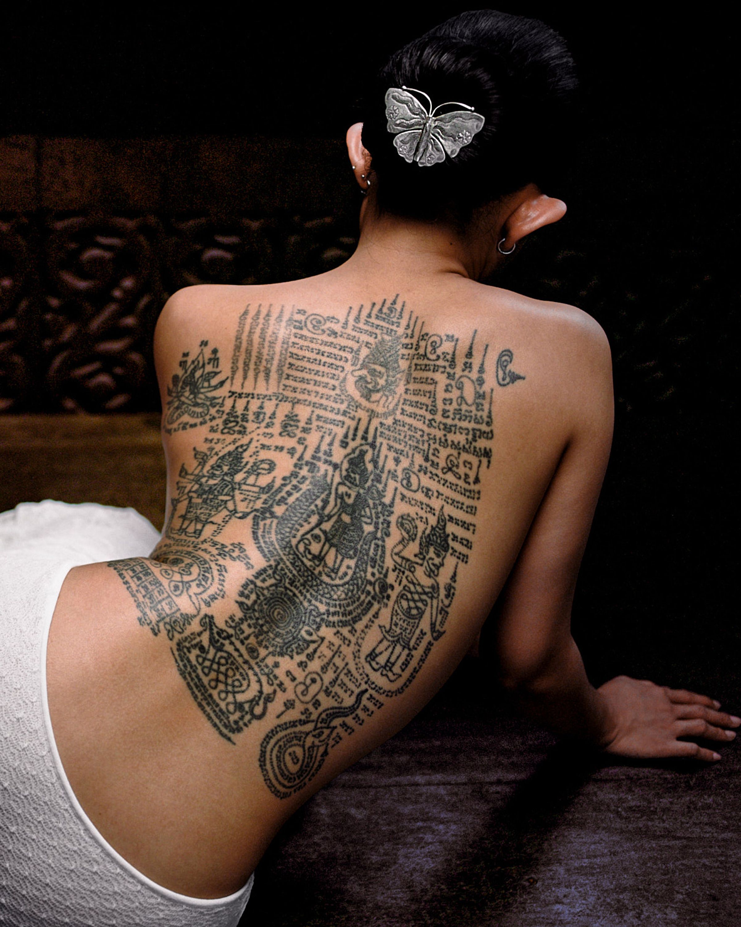 Tank Air SS24 ready-to-wear shot in Bangkok by Erika Kamano. Model with back tattoos wearing the Jellyfish Midi Skirt in Milk while lying in room.