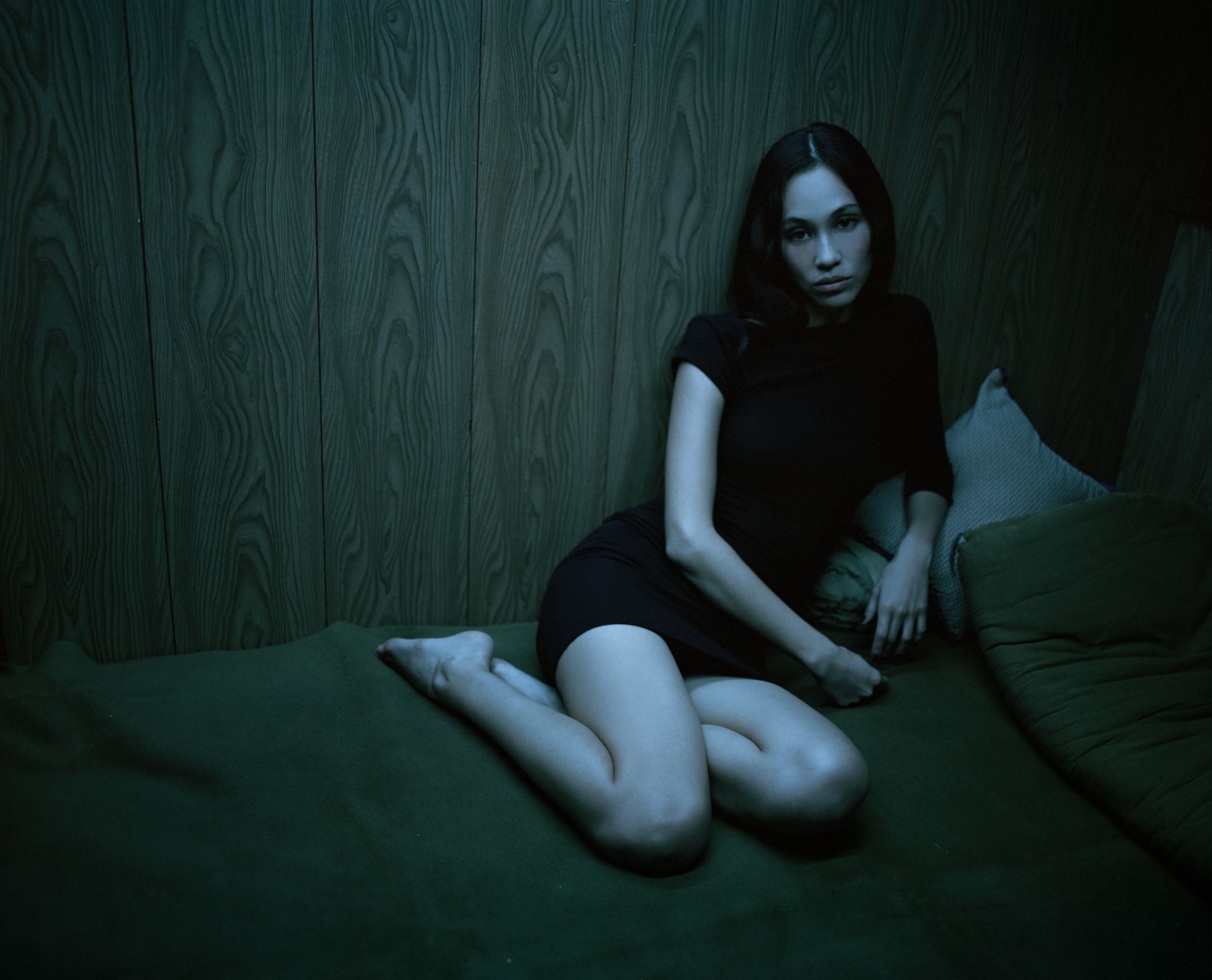 Tank Air FW24 ready-to-wear shot in Tokyo by Erika Kamano. Model wearing the Asymmetrical Pleated Mini Dress in Black while laying on bed.