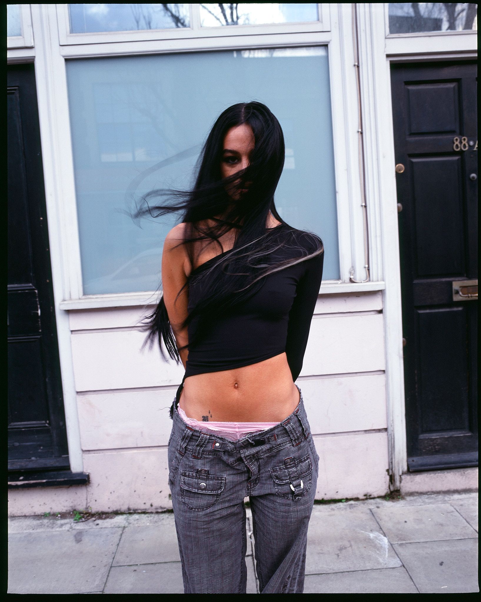 Tank Air SS21 Ready-to-Wear shot in London by Erika Kamano. Model wearing the Mai Thai top in Black on street.