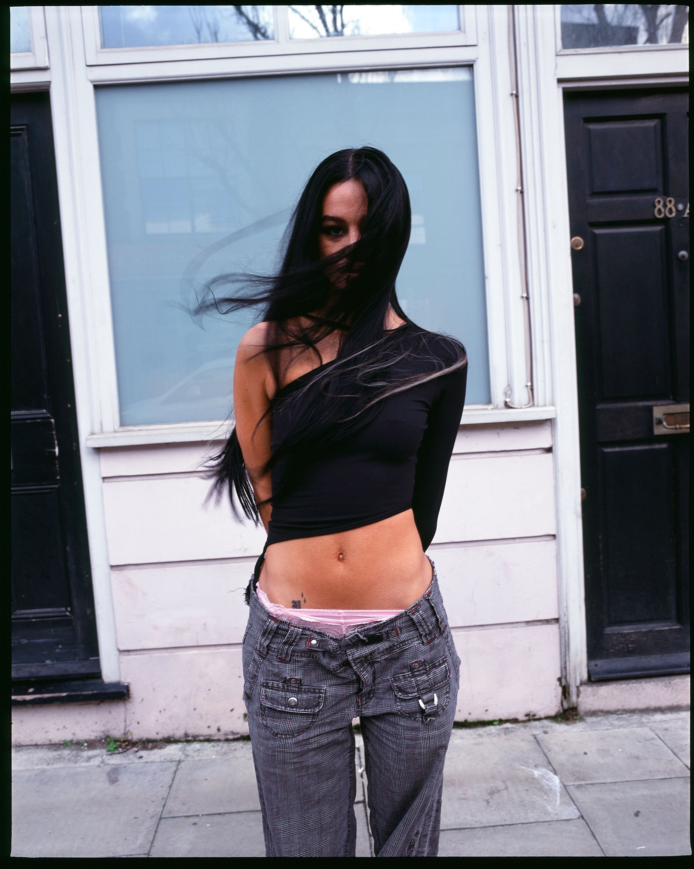 Tank Air SS21 Ready-to-Wear shot in London by Erika Kamano. Model wearing the Mai Thai top in Black on street.
