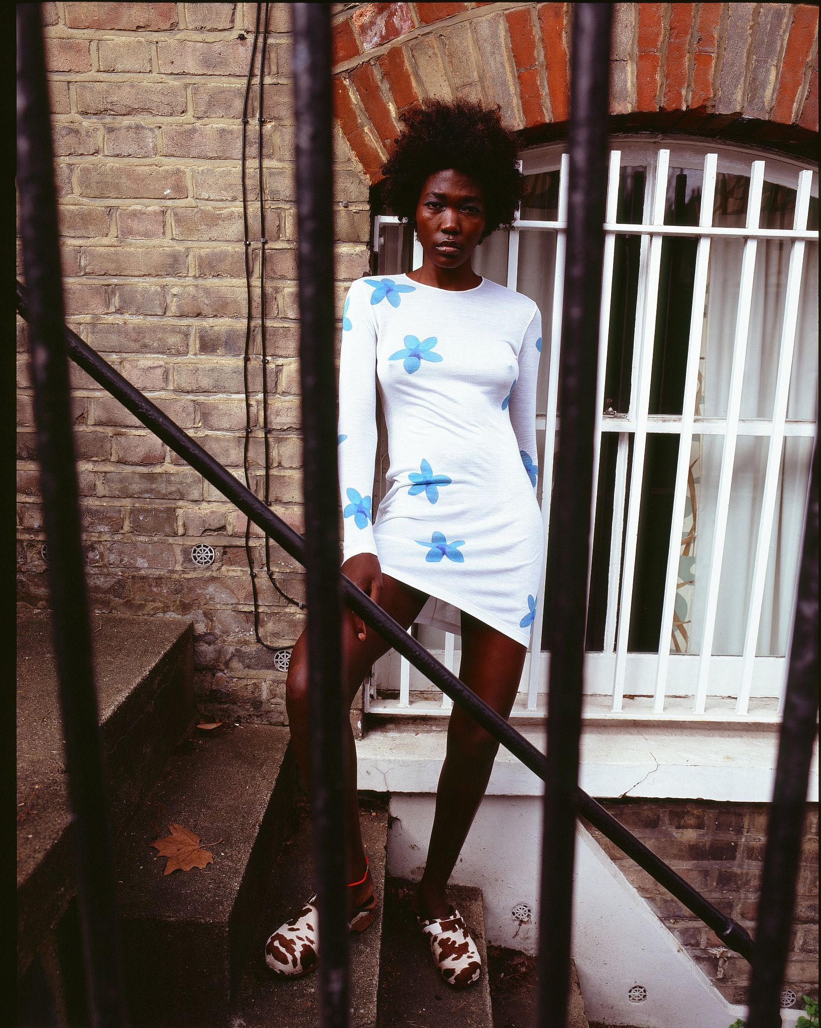 Tank Air SS21 Ready-to-Wear shot in London by Erika Kamano. Model wearing the Plumeria Dress while standing on street steps.