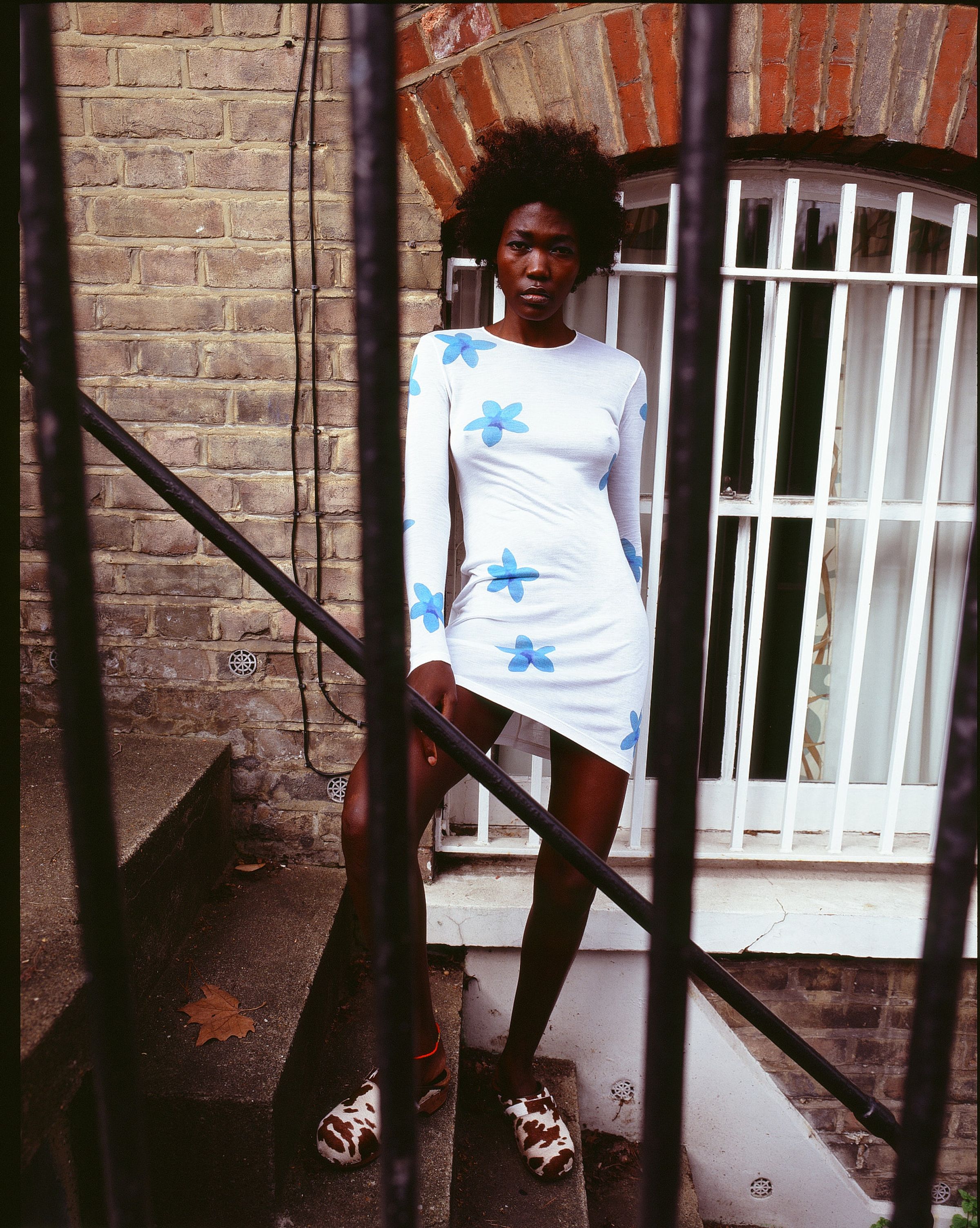Tank Air SS21 Ready-to-Wear shot in London by Erika Kamano. Model wearing the Plumeria Dress while standing on street steps.