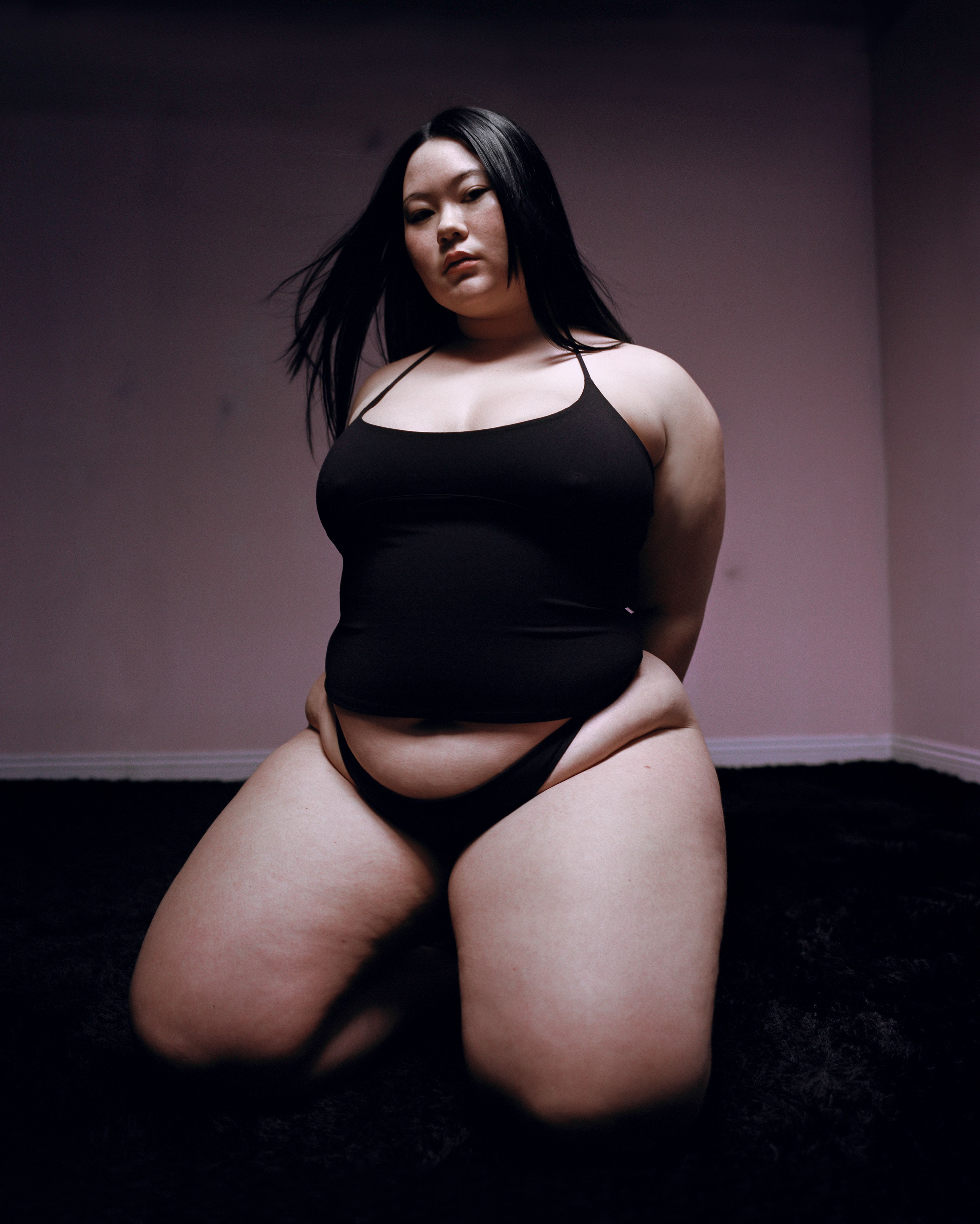 Tank Air SS23 Essentials shot in Los Angeles by Erika Kamano. Model wearing the Spill Halter in Black while kneeling on the floor.
