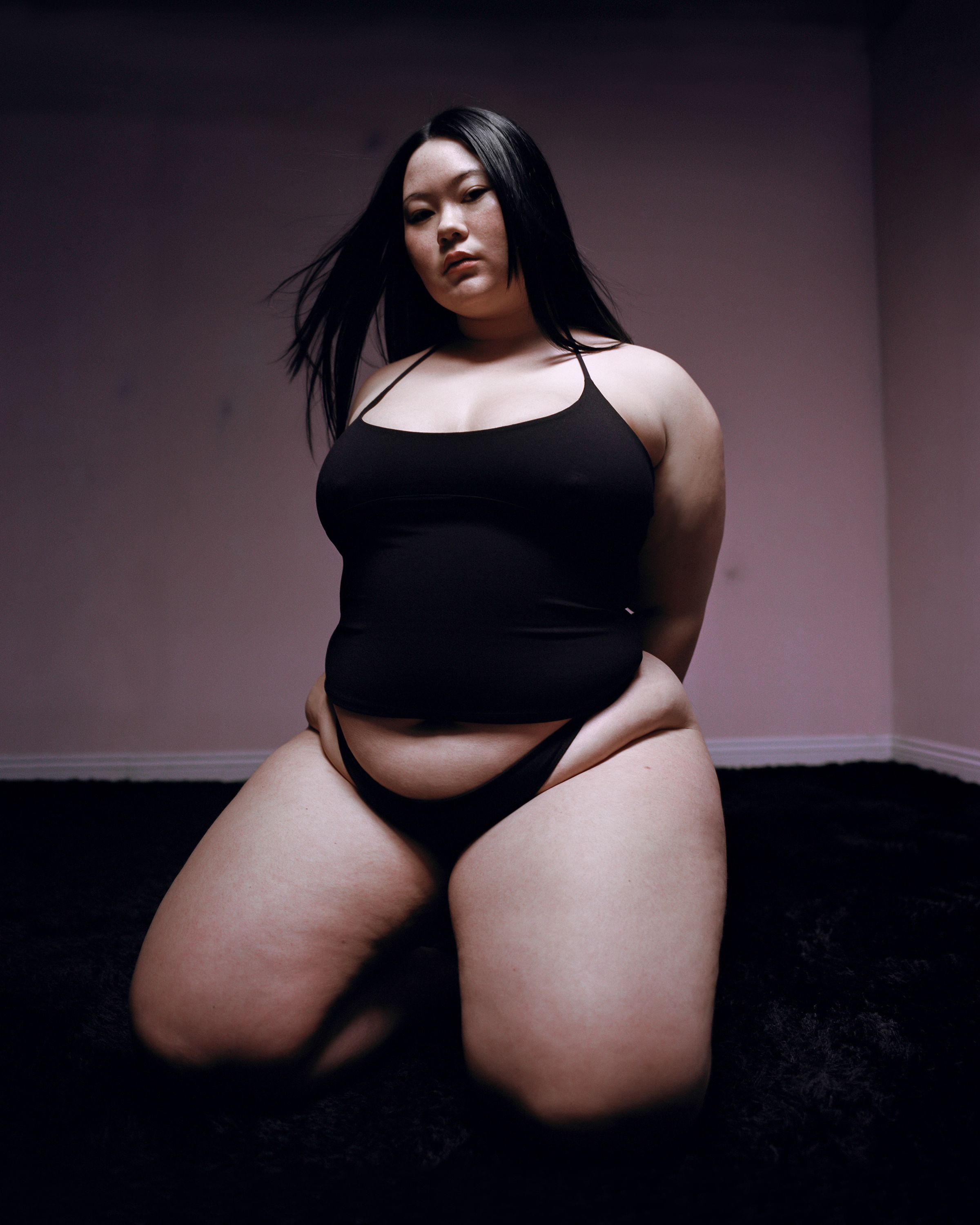 Tank Air SS23 Essentials shot in Los Angeles by Erika Kamano. Model wearing the Spill Halter in Black while kneeling on the floor.