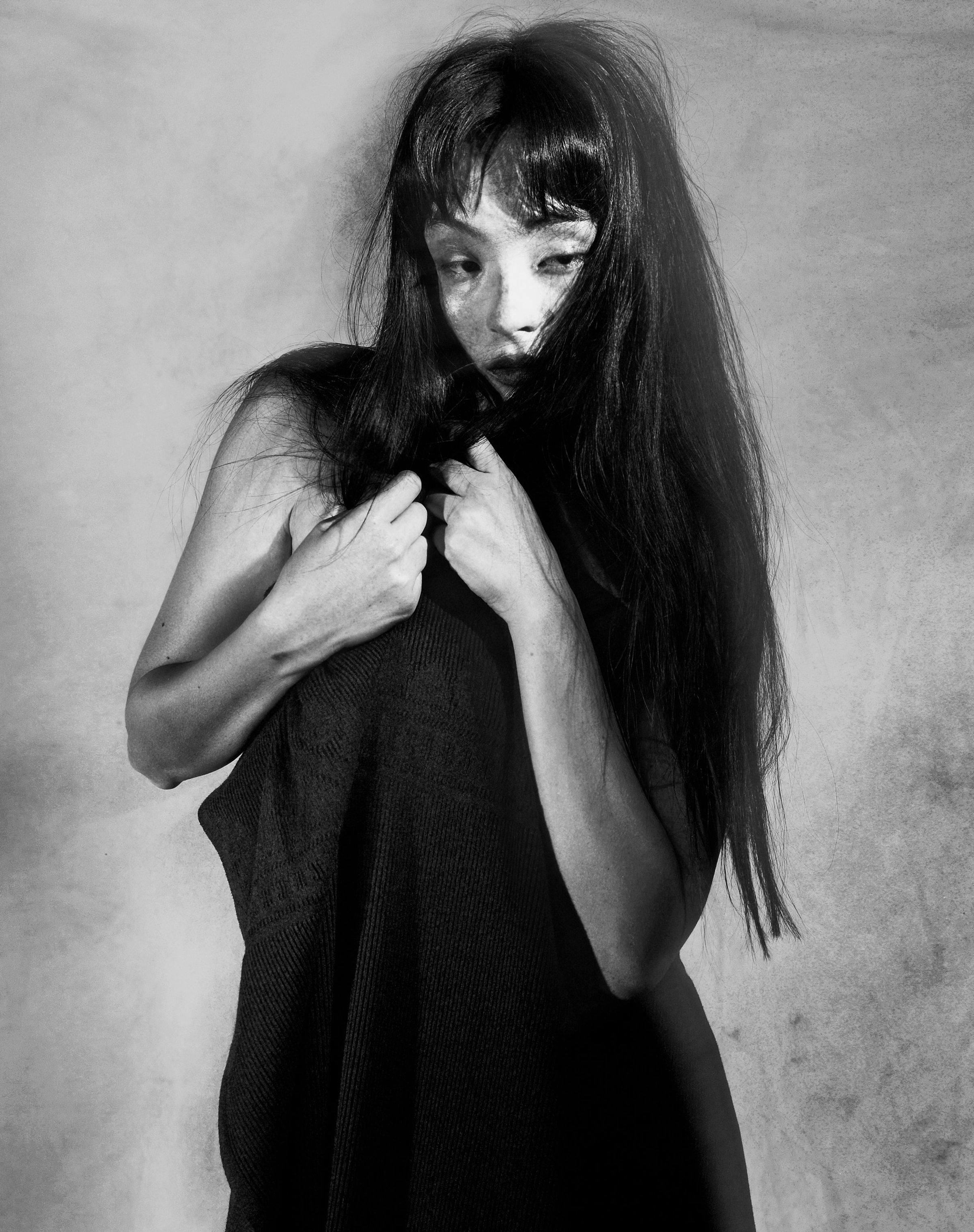 Tank Air FW25 ready-to-wear shot in Paris by Joe Lai. Model wearing the Tank Air Throw around her body in a half body portrait.