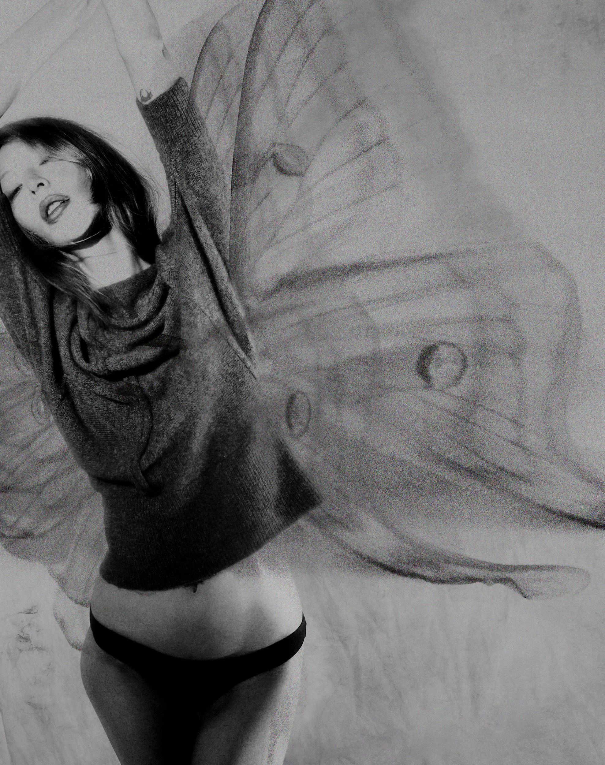 Tank Air FW25 ready-to-wear shot in Paris by Joe Lai. Model wearing the Cashmere Angel Sweater with pictured moth wings behind her body.