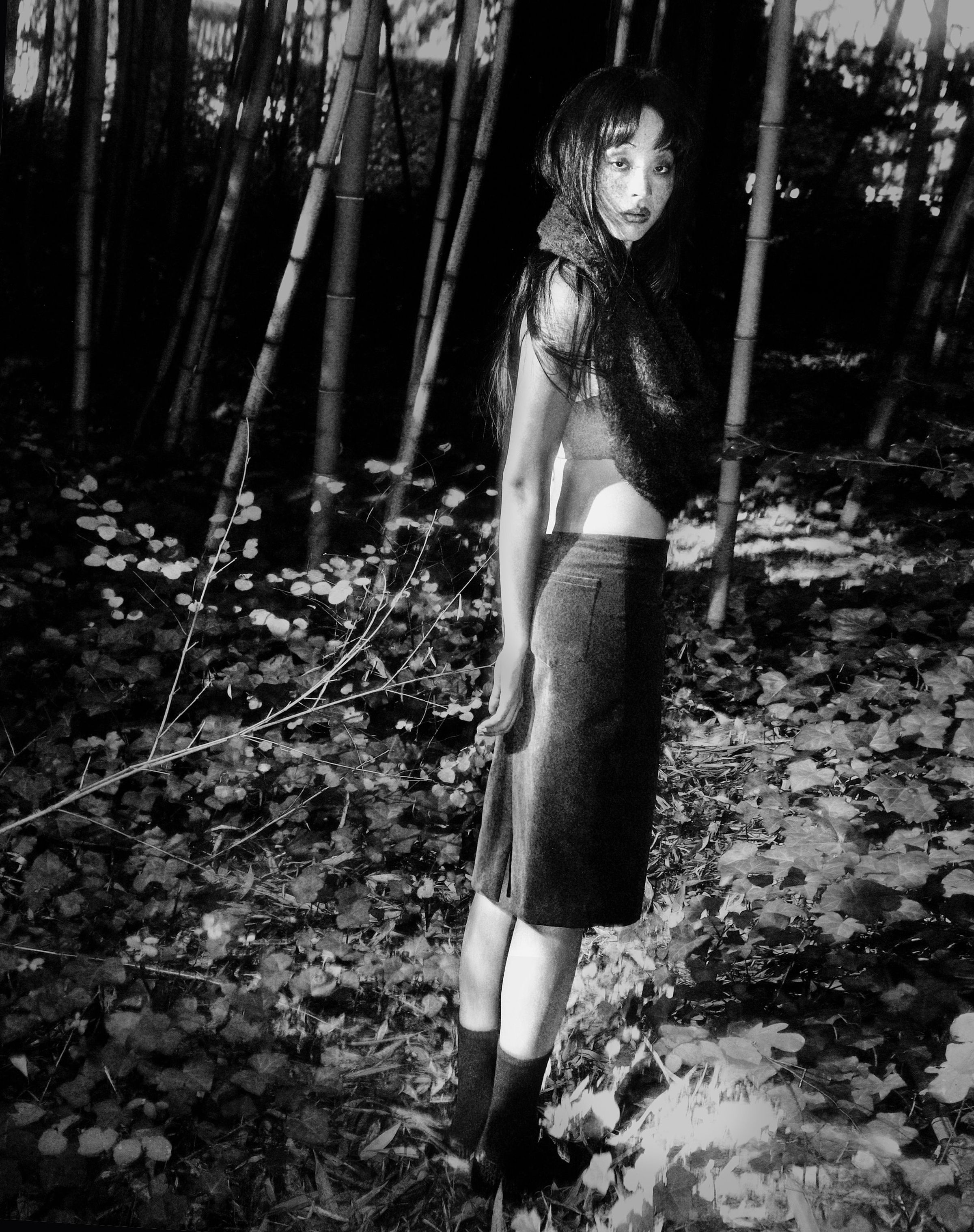 Tank Air FW25 ready-to-wear shot in Paris by Joe Lai. Model wearing the Velvet Midi Skirt and the Fluffies Scarf in Black while standing in nature.