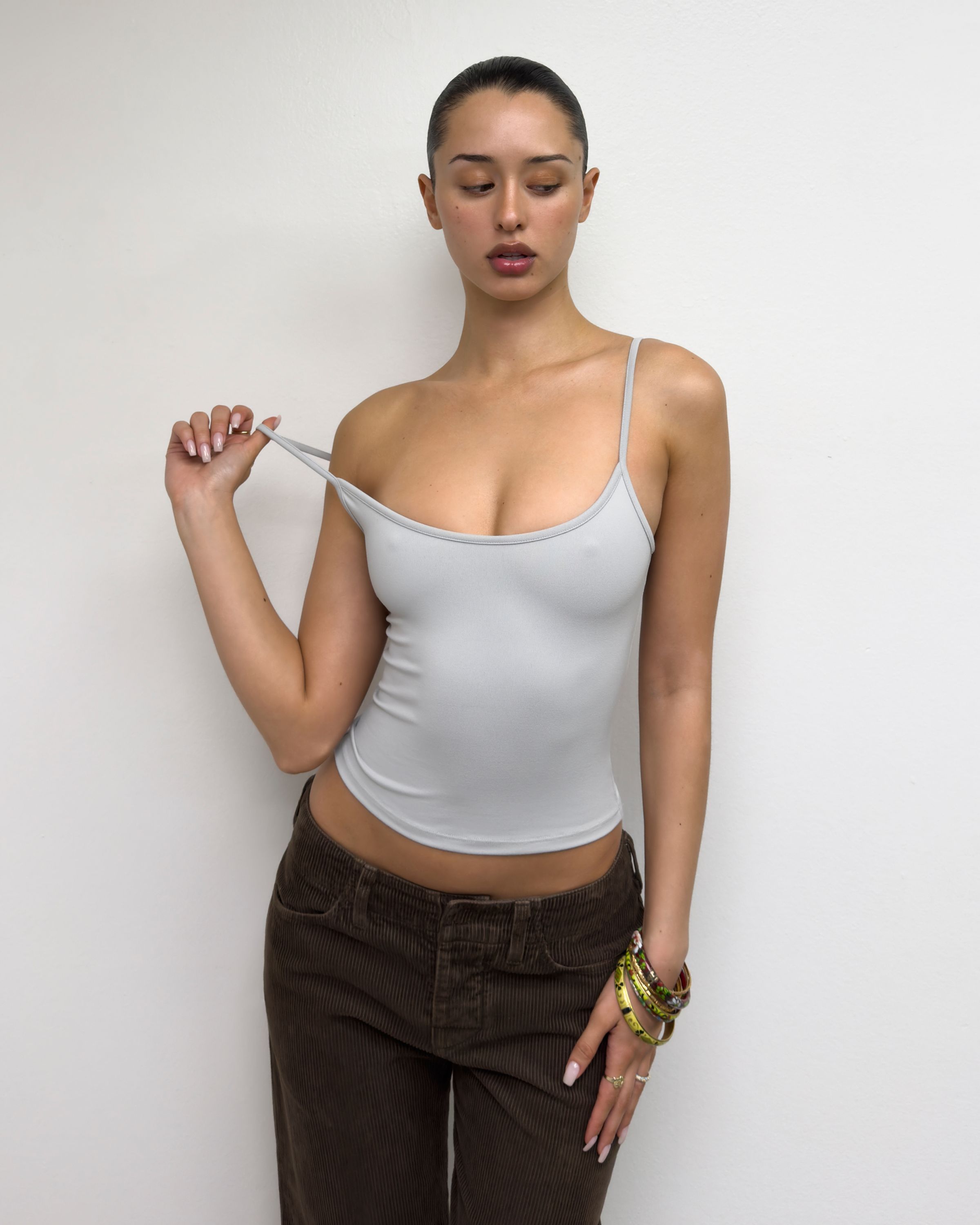 Tank Air SS25 Essentials shot in Los Angeles by Tank Air. Model wearing Studio Tank in Mist against white wall.